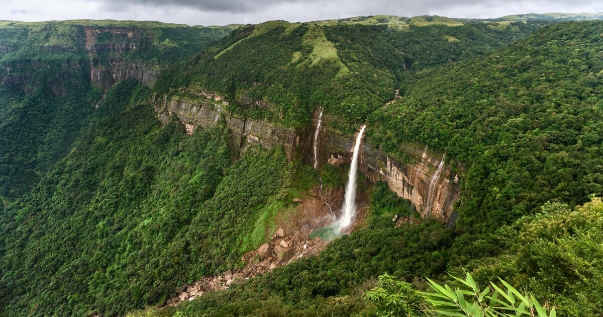 Nohkalikai Falls surrounded by lush green hills in Meghalaya, Northeast India