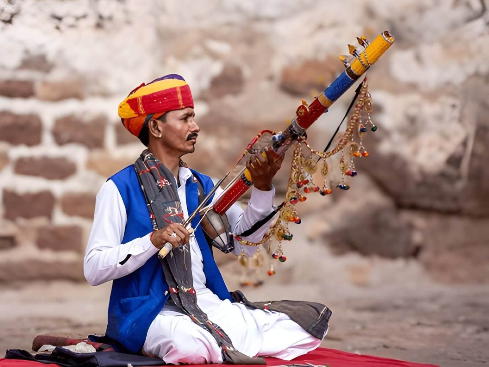 Traditional Rajasthani folk musician performing with a string instrument
