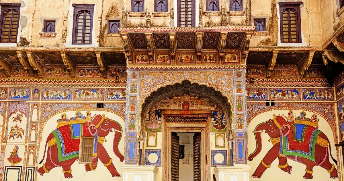 Intricately painted Mandawa Haveli facade featuring colorful elephant frescoes and traditional Rajasthani artwork in Rajasthan, India