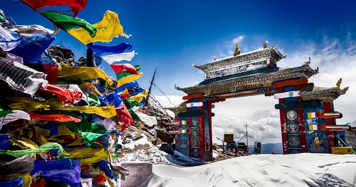 Snow-covered Sela Pass with colorful prayer flags in Arunachal Pradesh